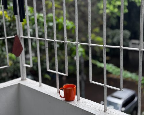 Woman drinking tea looking out window peaceful morning